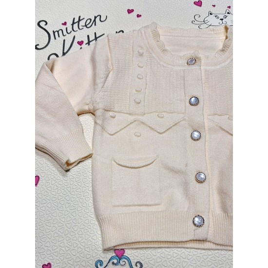 Луксозна детска жилетка от фино плетиво в екрю Луксозна детска жилетка от фино плетиво в екрю